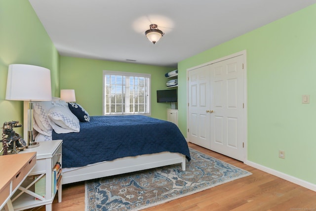 bedroom featuring a closet and light hardwood / wood-style flooring