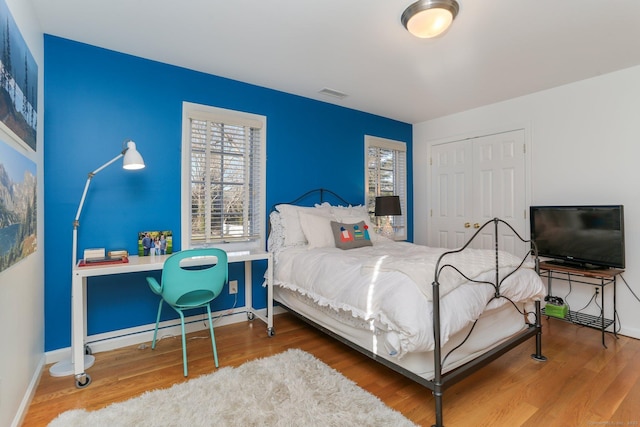 bedroom featuring wood-type flooring and a closet