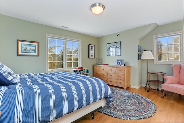 bedroom with hardwood / wood-style flooring