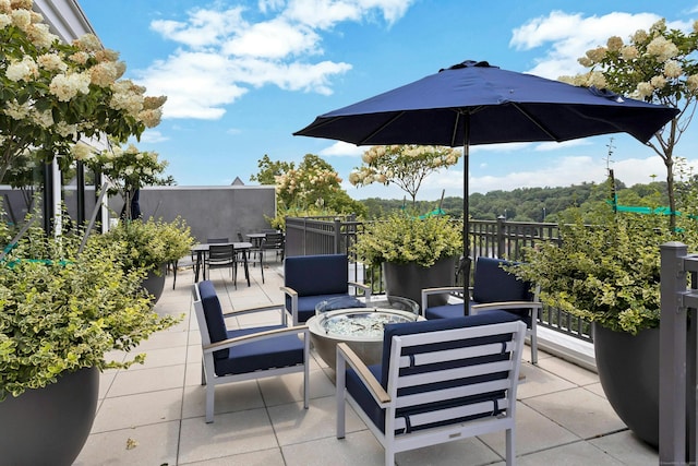 view of patio / terrace with an outdoor living space with a fire pit