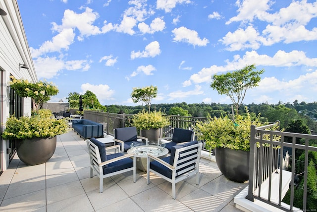 view of patio / terrace with an outdoor living space with a fire pit