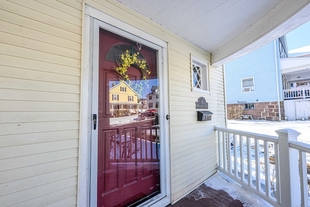 view of snow covered property entrance