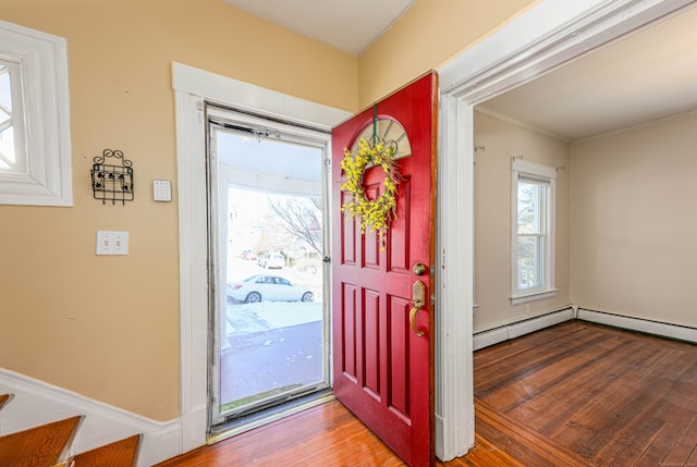 foyer featuring wood-type flooring and baseboard heating