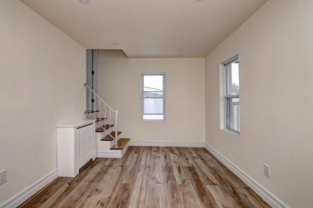 702 King St, Stratford, CT 06614 - empty room with stairway, light wood-style floors, plenty of natural light, and baseboards