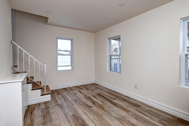 702 King St, Stratford, CT 06614 - unfurnished room with light wood-type flooring, stairway, and baseboards