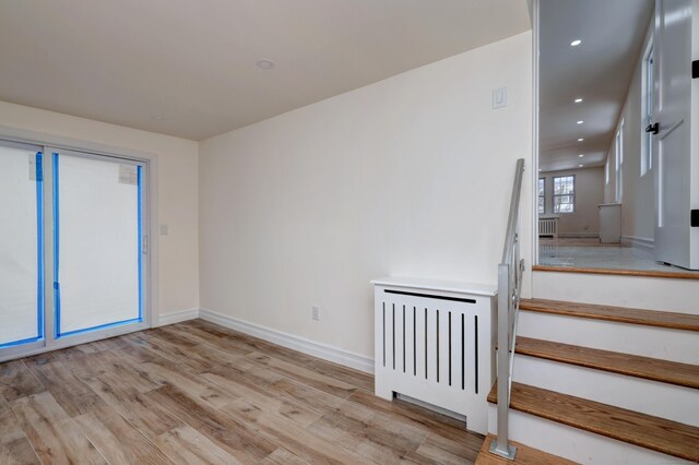 702 King St, Stratford, CT 06614 - spare room with light wood-style flooring, recessed lighting, baseboards, and stairway