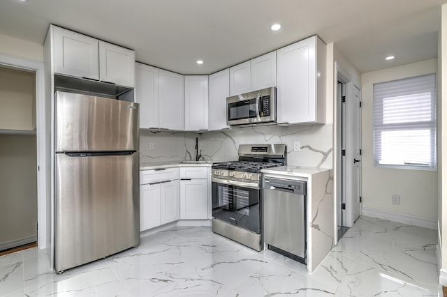702 King St, Stratford, CT 06614 - kitchen featuring stainless steel appliances, white cabinetry, light marble finish floors, recessed lighting, and baseboards