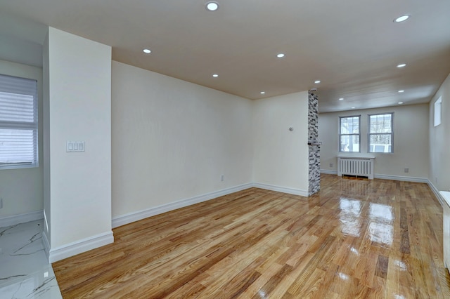 702 King St, Stratford, CT 06614 - spare room featuring radiator, recessed lighting, light wood-style flooring, and baseboards