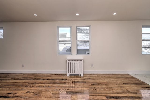 702 King St, Stratford, CT 06614 - spare room featuring radiator, recessed lighting, baseboards, and wood finished floors