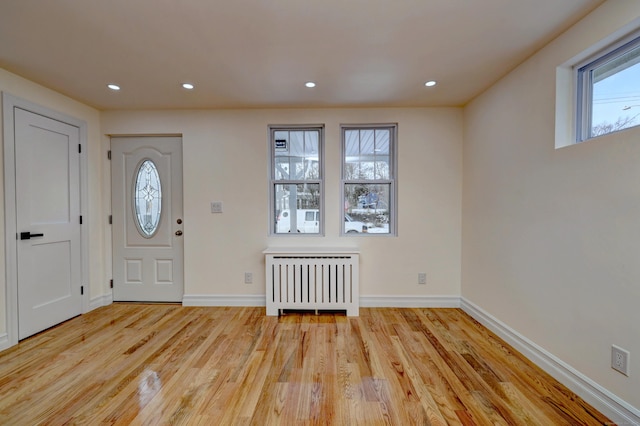 702 King St, Stratford, CT 06614 - foyer entrance with radiator heating unit, wood finished floors, recessed lighting, and baseboards