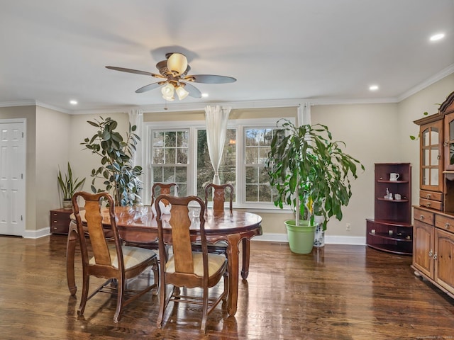 dining room featuring ornamental molding, dark wood-type flooring, and ceiling fan