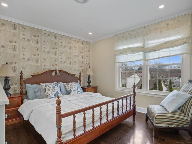 bedroom with ornamental molding and dark hardwood / wood-style floors