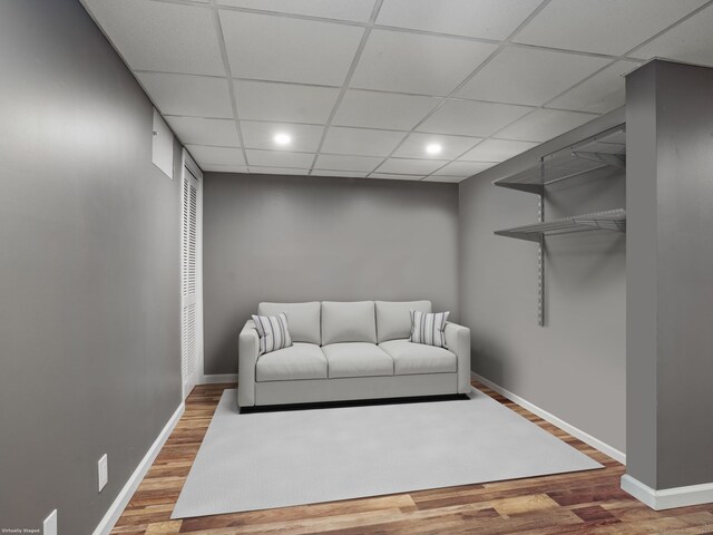 living room with hardwood / wood-style flooring and a drop ceiling