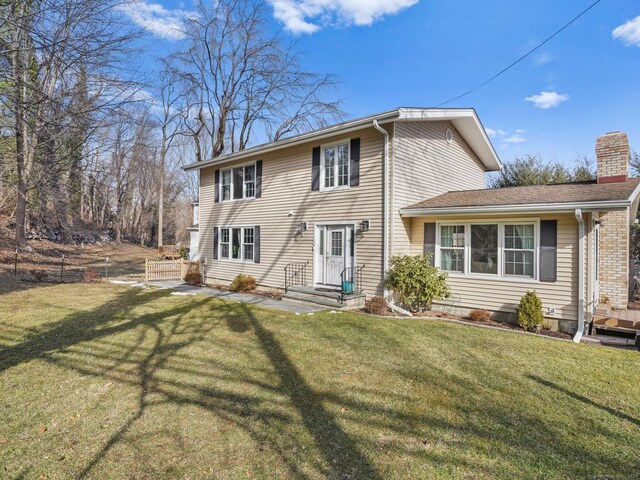 back of house featuring a yard