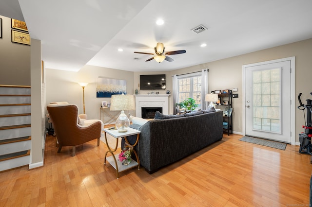 living room with ceiling fan and light wood-type flooring