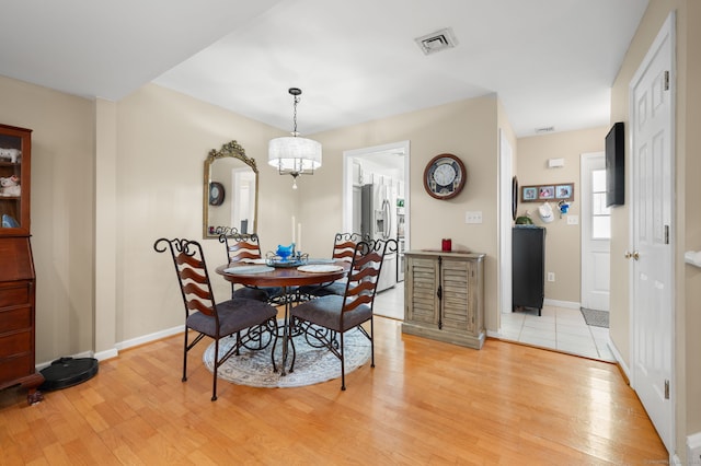 dining space with light hardwood / wood-style floors