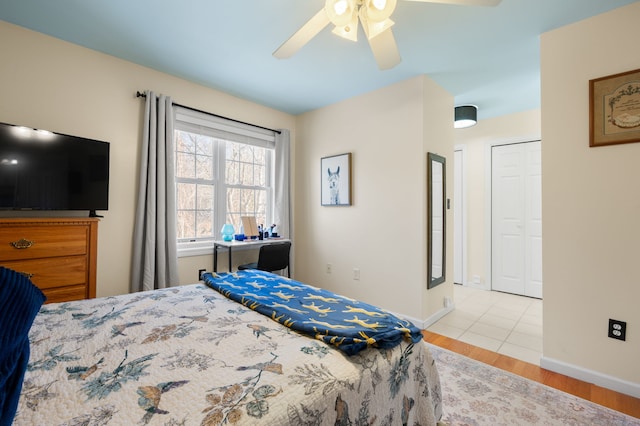 bedroom featuring a closet, ceiling fan, and light wood-type flooring