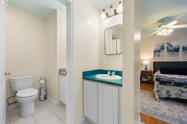 bathroom with tile patterned flooring, vanity, ceiling fan, and toilet