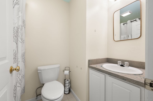 bathroom with vanity, tile patterned floors, and toilet