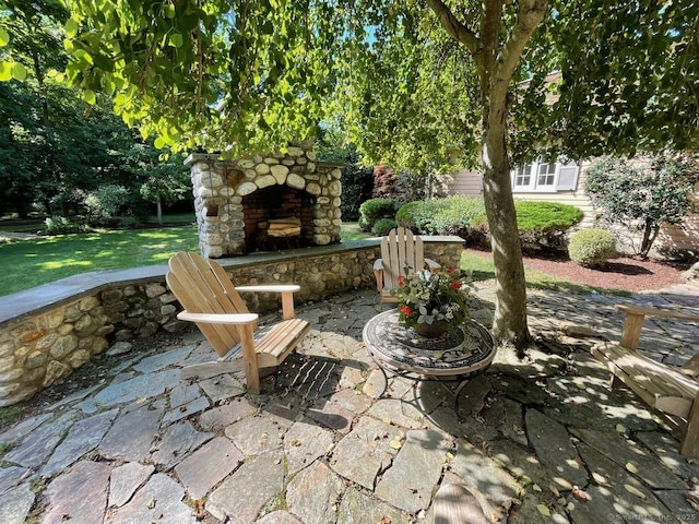 view of patio featuring an outdoor stone fireplace