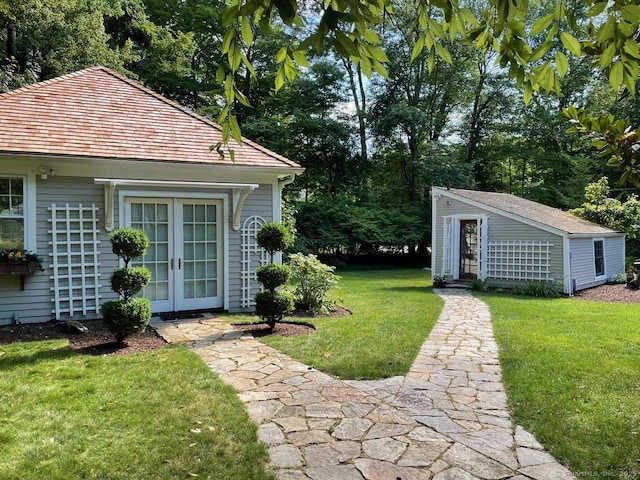 view of yard featuring french doors and an outbuilding