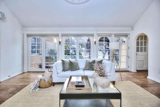 sunroom / solarium featuring vaulted ceiling and a healthy amount of sunlight