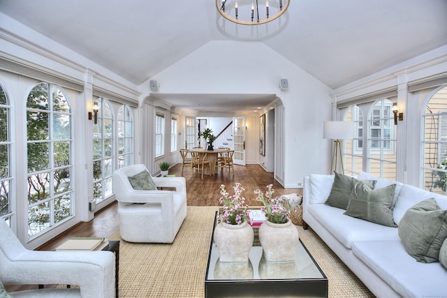 sunroom / solarium with an inviting chandelier and lofted ceiling