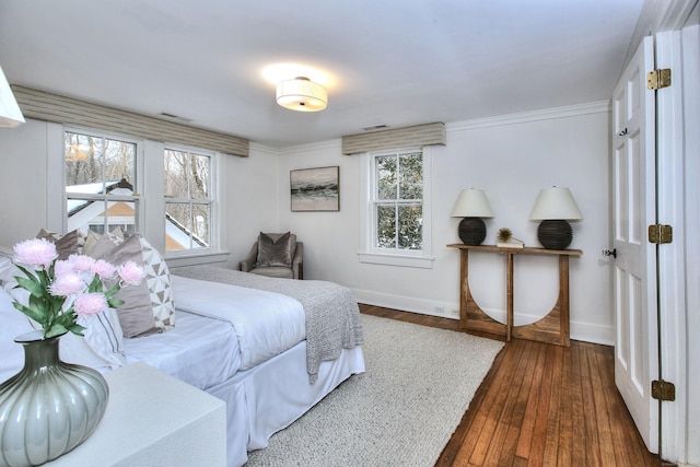 bedroom with crown molding and dark hardwood / wood-style floors