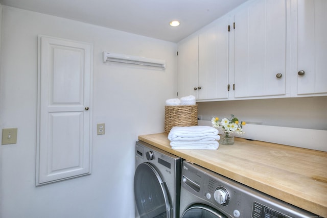 laundry area with washer and dryer and cabinets