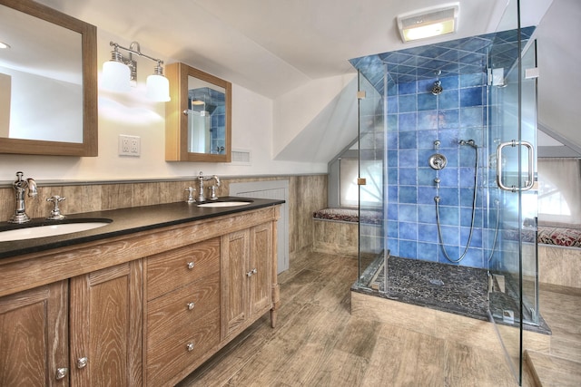 bathroom with vanity, hardwood / wood-style floors, an enclosed shower, and vaulted ceiling