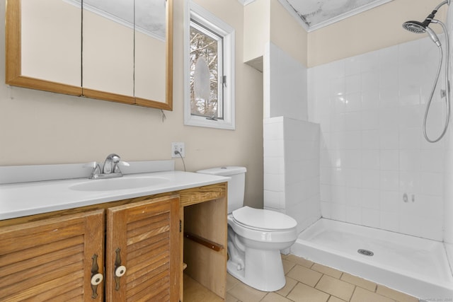 bathroom with toilet, vanity, walk in shower, crown molding, and tile patterned floors