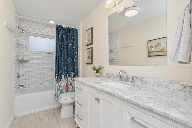 full bathroom with shower / tub combo with curtain, vanity, and toilet