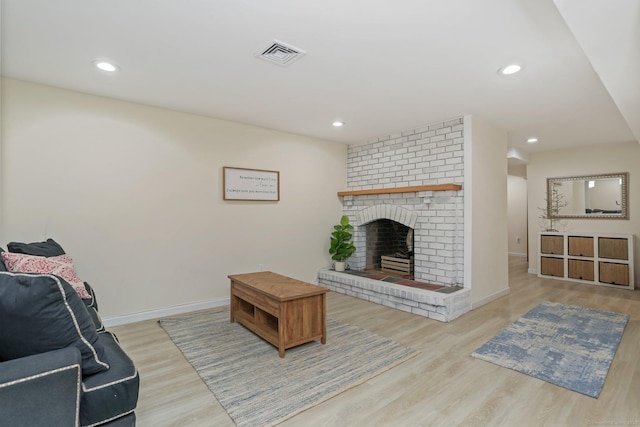 living room with a fireplace and light hardwood / wood-style floors