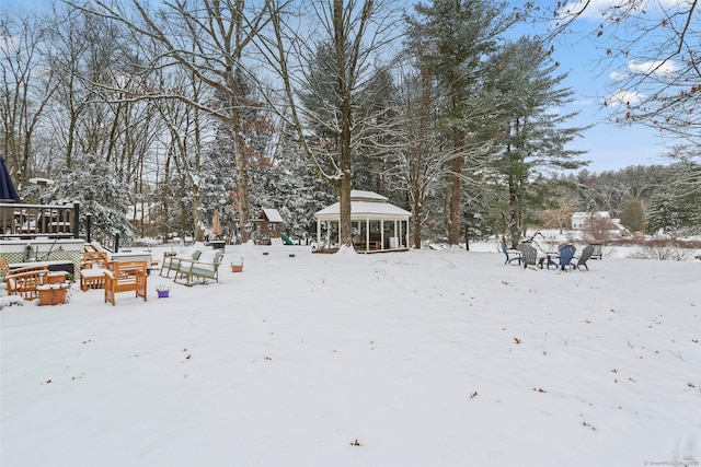 snowy yard with a gazebo