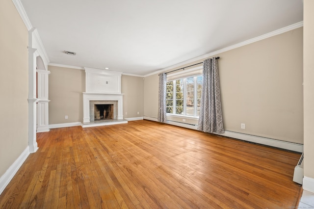 unfurnished living room featuring a large fireplace, ornamental molding, light hardwood / wood-style flooring, and a baseboard heating unit