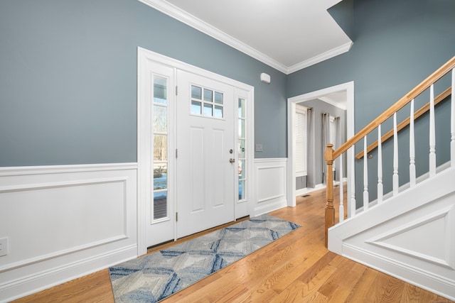 foyer with crown molding and wood-type flooring