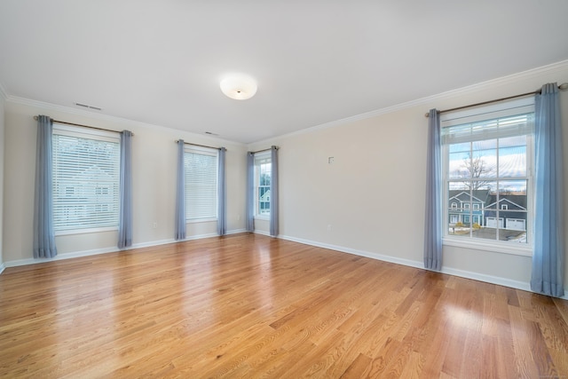 unfurnished room featuring ornamental molding and light hardwood / wood-style floors