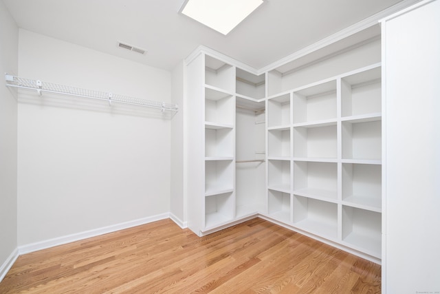 walk in closet with hardwood / wood-style floors