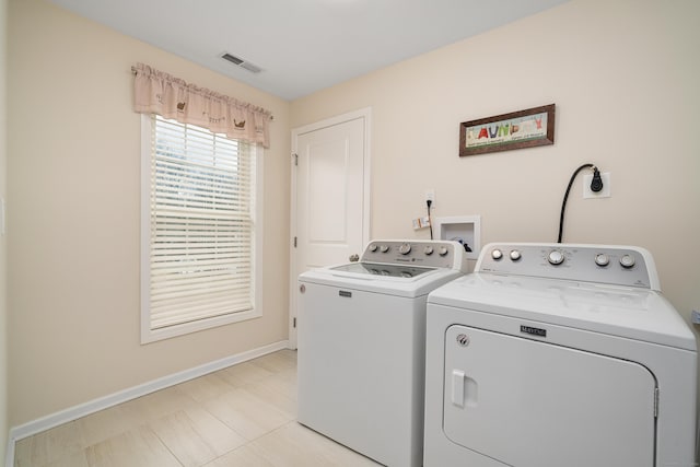 clothes washing area featuring washer and clothes dryer