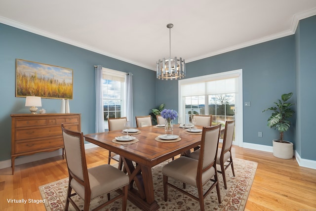 dining space featuring a notable chandelier, light hardwood / wood-style floors, and a healthy amount of sunlight