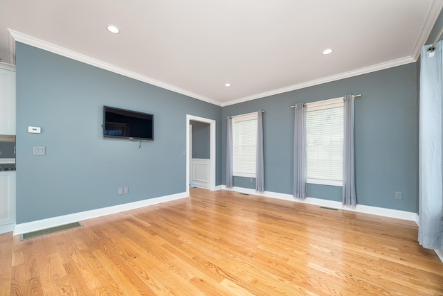 spare room with crown molding and light hardwood / wood-style floors