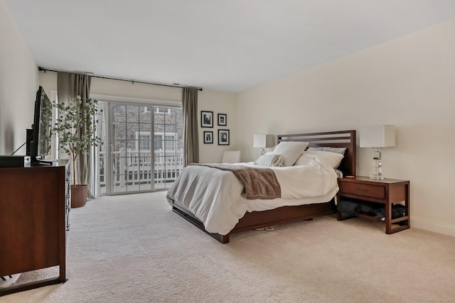 bedroom with light carpet, access to outside, and baseboards