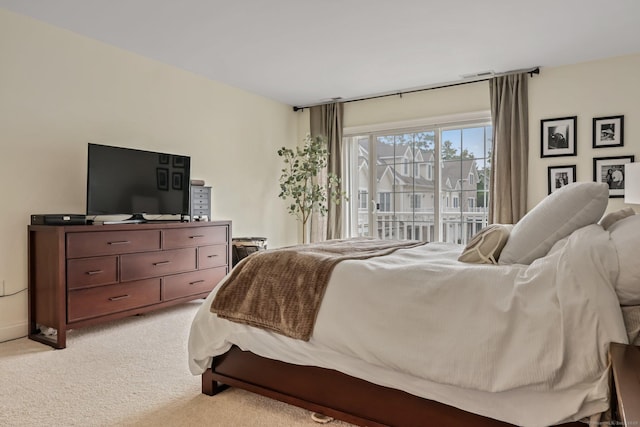 bedroom with access to outside, light colored carpet, and visible vents