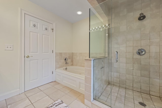 full bath featuring tile patterned flooring, a shower stall, and a bath