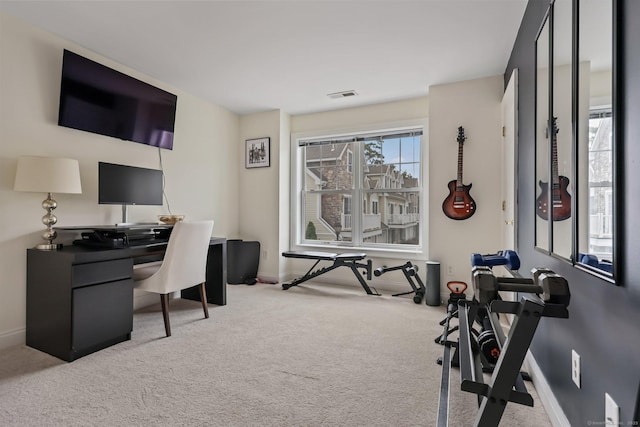 office space featuring light carpet, visible vents, and baseboards