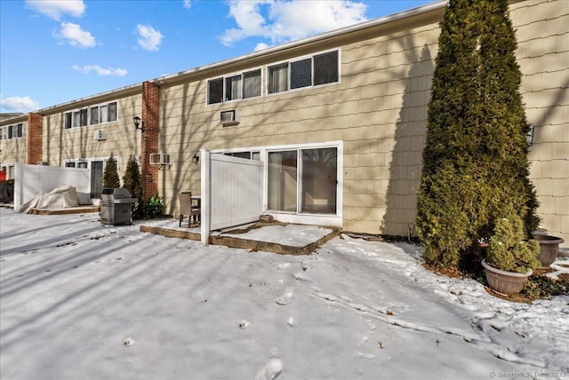 view of snow covered rear of property