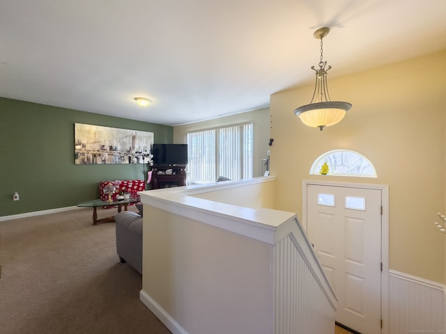 foyer entrance with carpet flooring