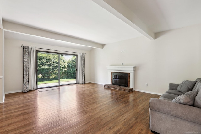 957A Heritage Vlg, Southbury, CT 06488 - living area with wood finished floors, a brick fireplace, beamed ceiling, and baseboards
