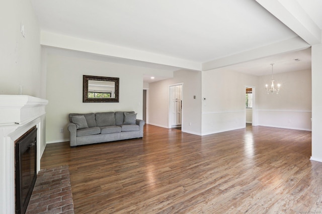 957A Heritage Vlg, Southbury, CT 06488 - living room featuring a chandelier, a glass covered fireplace, wood finished floors, baseboards, and wine cooler