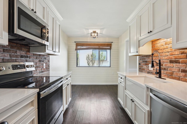 957A Heritage Vlg, Southbury, CT 06488 - kitchen featuring stainless steel appliances, light countertops, a sink, dark wood-type flooring, and white cabinetry